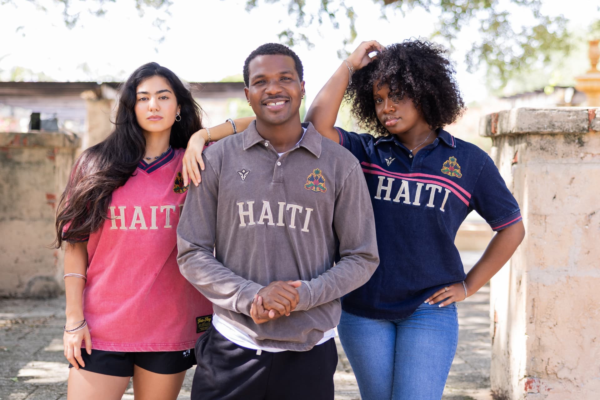 Three friends in Rezilyan Haiti jerseys laughing together